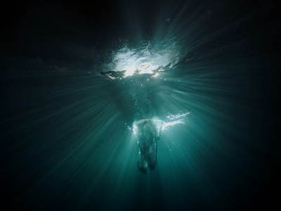 an underwater view of a person swimming in the water