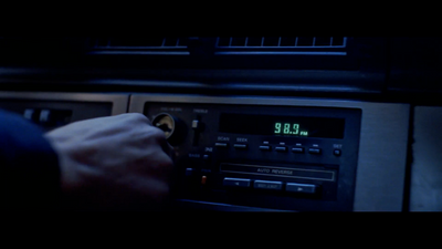 a person turning on a radio in a dark room