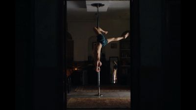 a man is doing a handstand on a pole