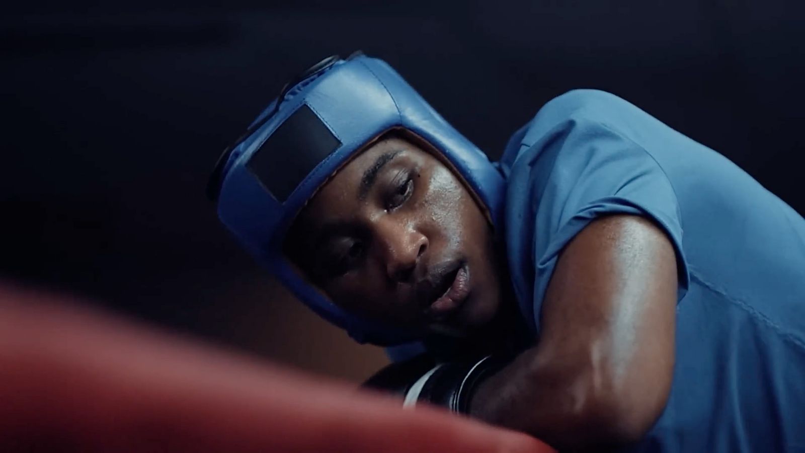 a man in a blue shirt and blue headgear