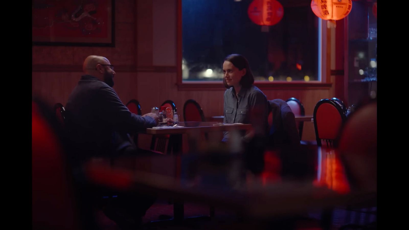 a man and a woman sitting at a table in a restaurant