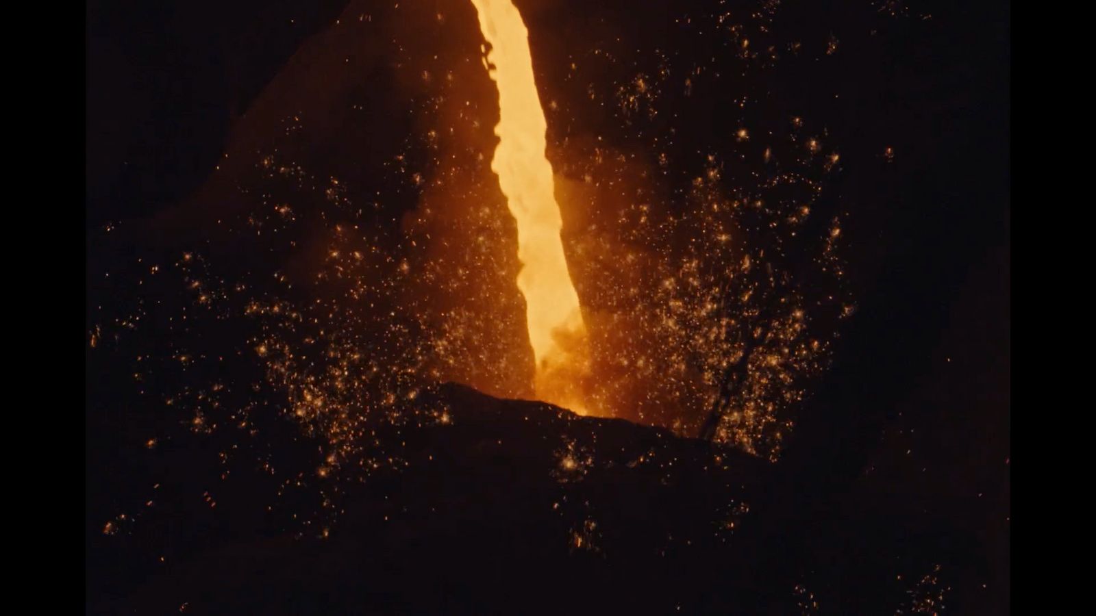 a large fire is coming out of a cave