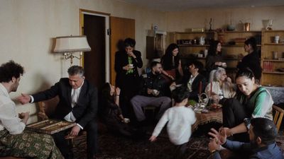 a group of people sitting around a living room together