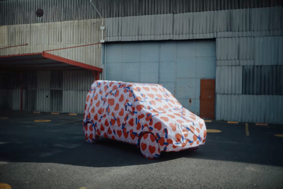 a car covered in a large piece of paper