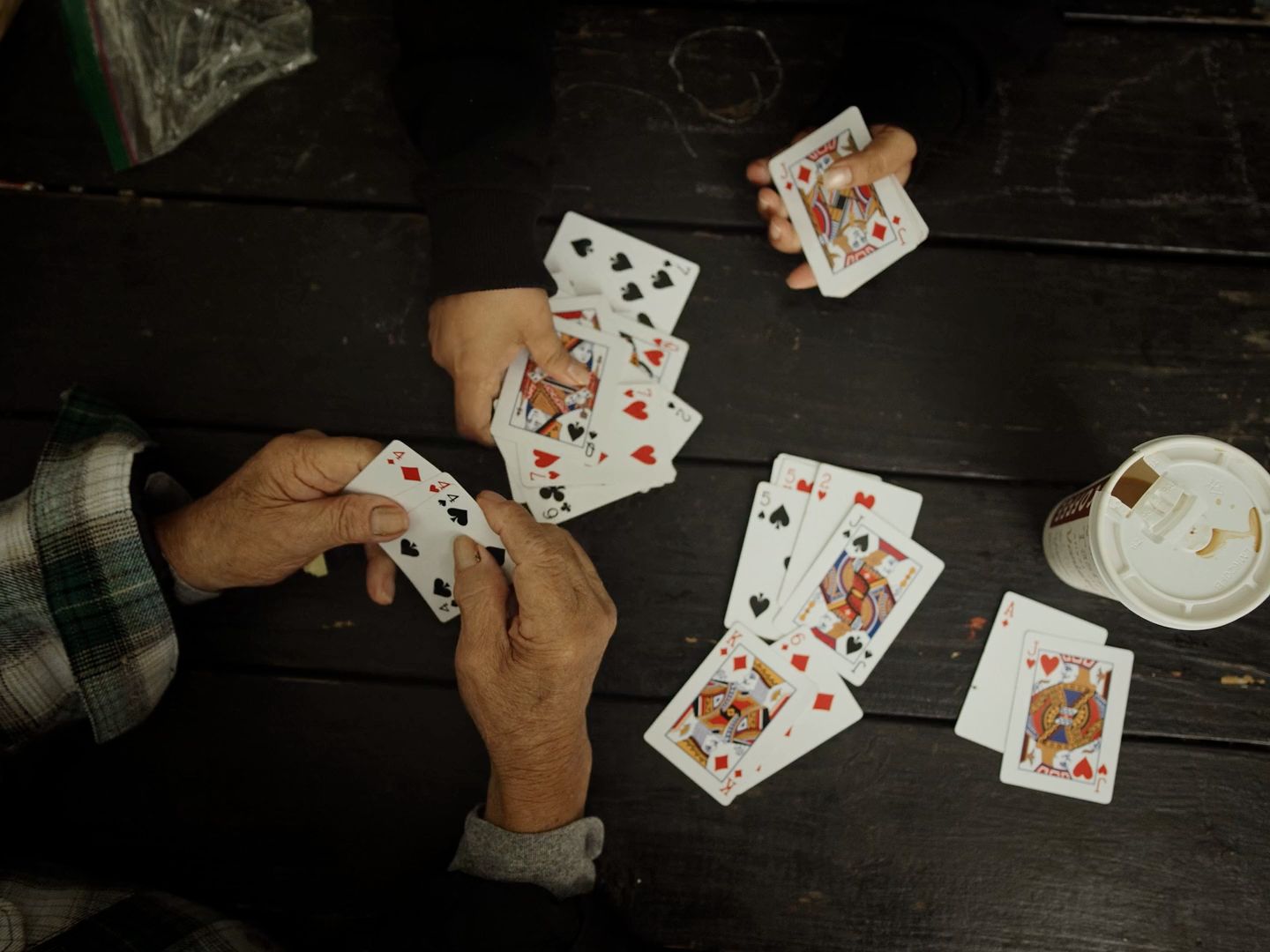 a group of people playing cards on a table