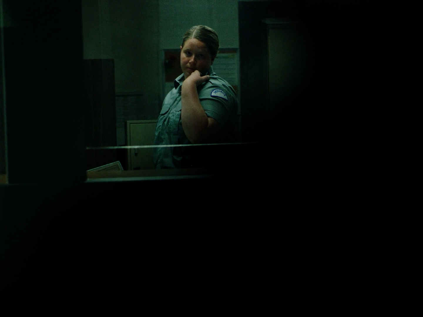 a woman standing in front of a mirror in a dark room