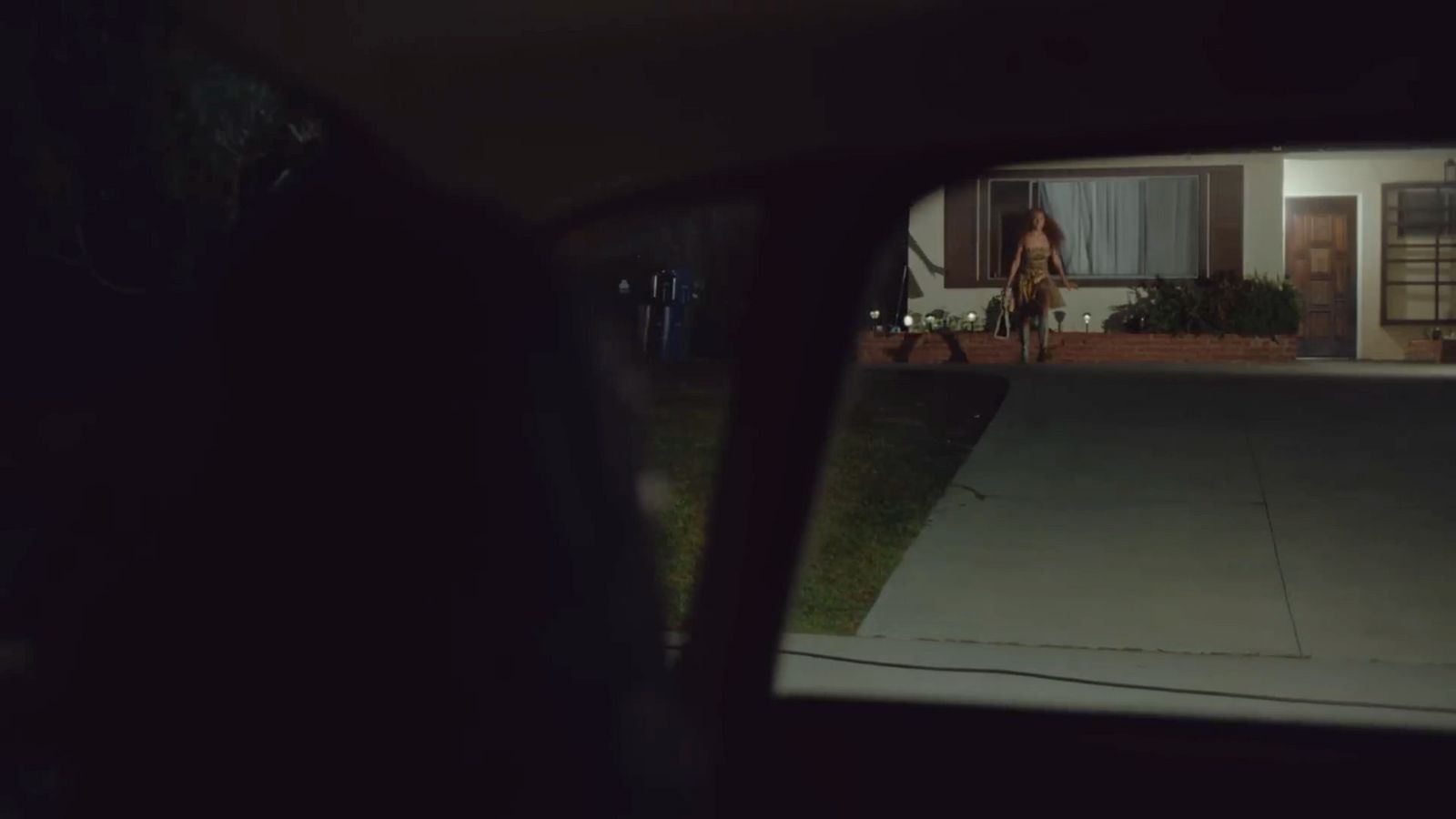 a woman walking down a street at night