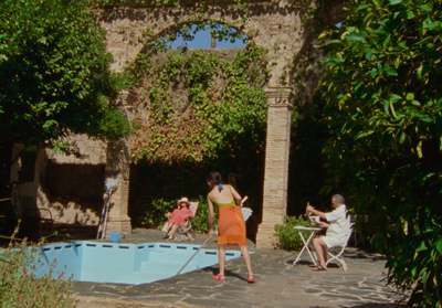 a group of people sitting around a swimming pool