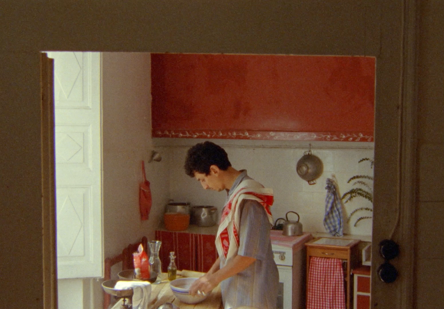 a man standing in a kitchen preparing food