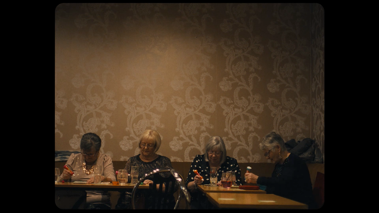 a group of people sitting at a table in a restaurant