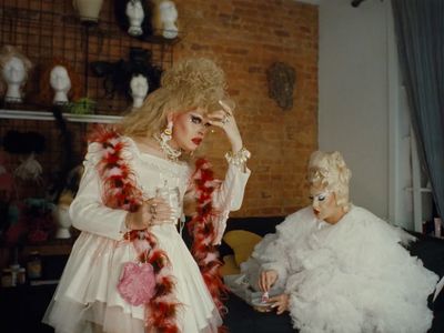 two women dressed in costumes sitting on a couch