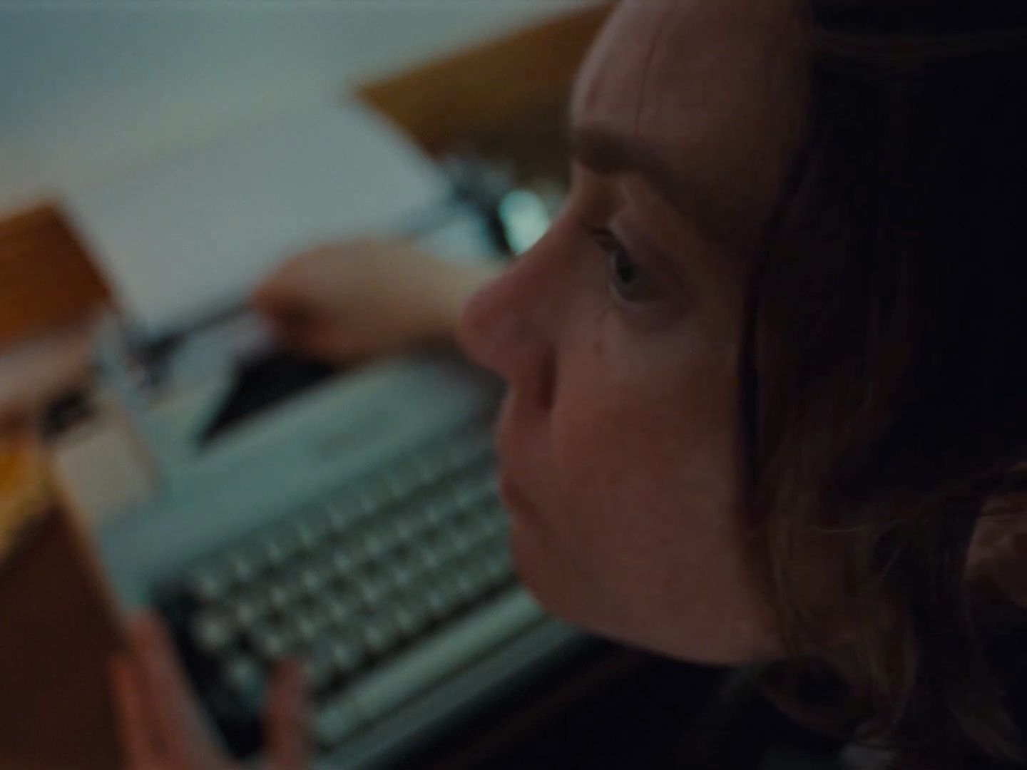 a close up of a person typing on a typewriter