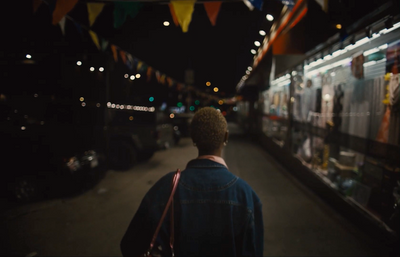 a man walking down a street at night