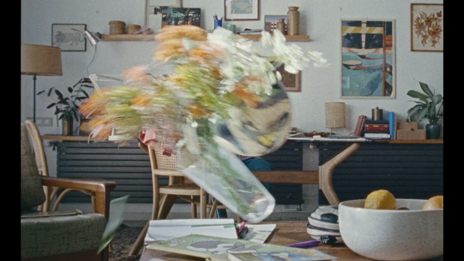 a vase filled with flowers sitting on top of a table