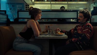 a man and a woman sitting at a table in a restaurant