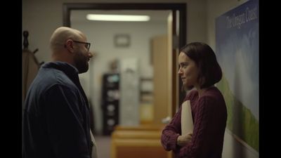 a man standing next to a woman in a hallway