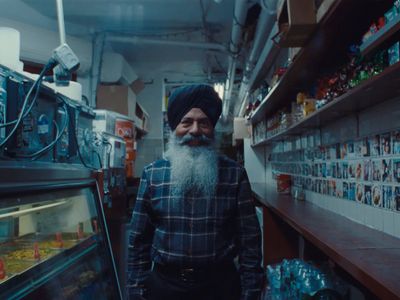 a man with a long beard standing in a store