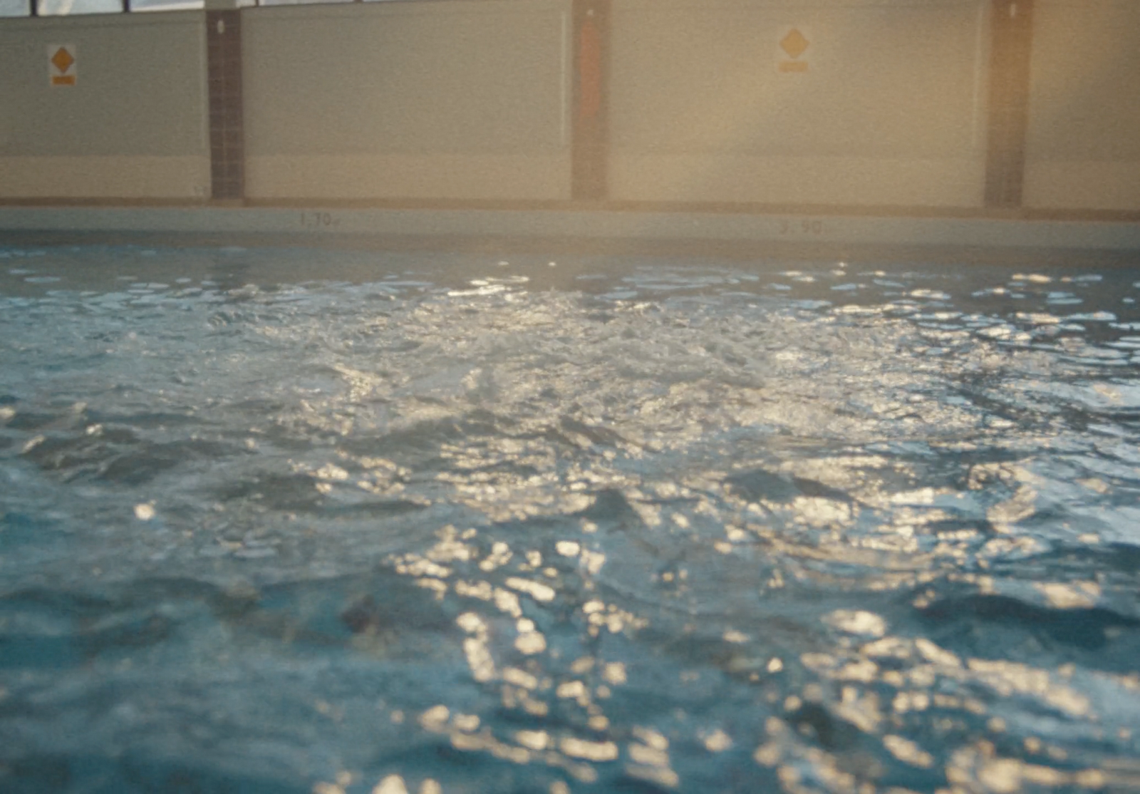 a large swimming pool with clear blue water