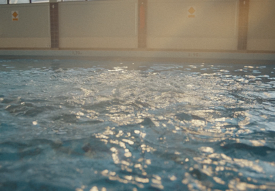 a large swimming pool with clear blue water