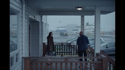 a man and a woman standing on a porch