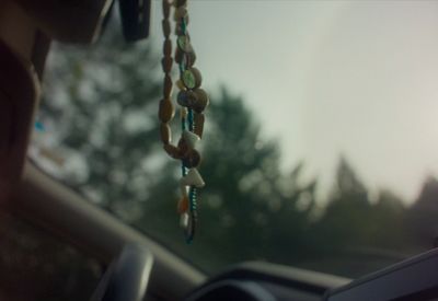 a car dashboard with beads hanging from the dash