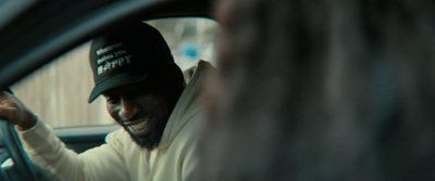 a man wearing a hat sitting in a car