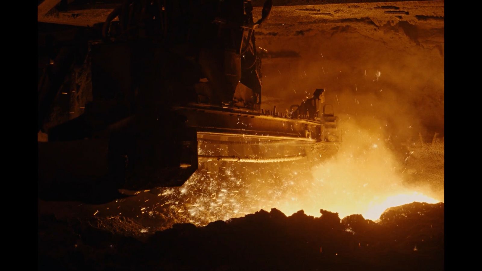 a large piece of metal being poured in a furnace