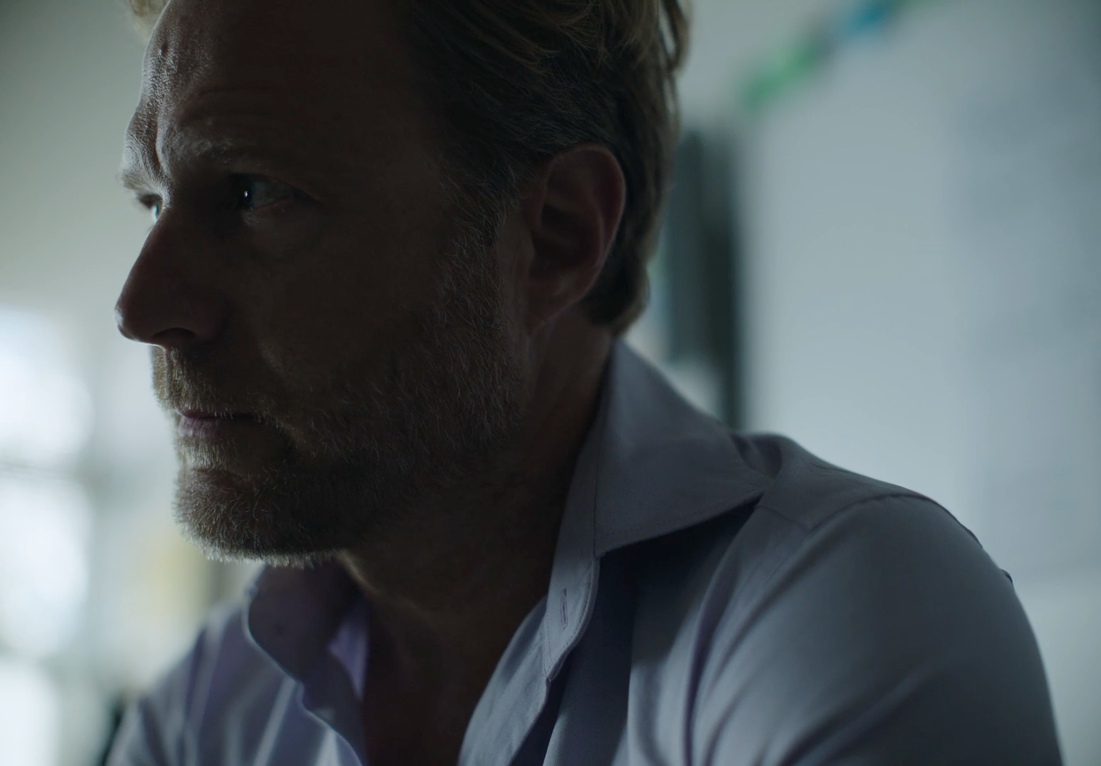 a close up of a person wearing a white shirt