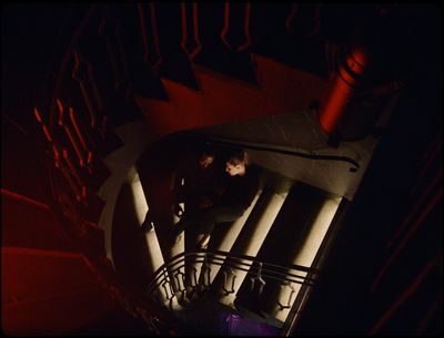 a person standing on a staircase in the dark