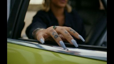 a woman's hand with a ring on top of it