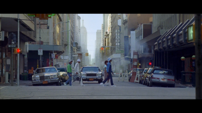 a group of people walking across a street