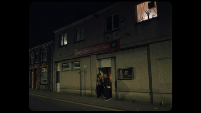 a couple of people standing outside of a building