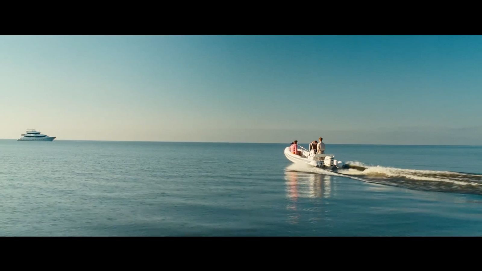 a small boat traveling across a large body of water