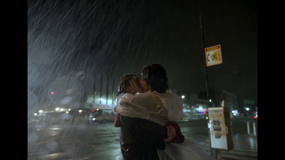 a couple of people that are standing in the rain