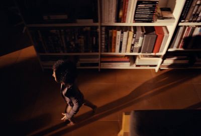 a person standing in front of a book shelf