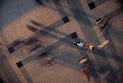 a group of people walking down a street next to each other