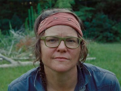 a woman wearing glasses and a bandana on her head