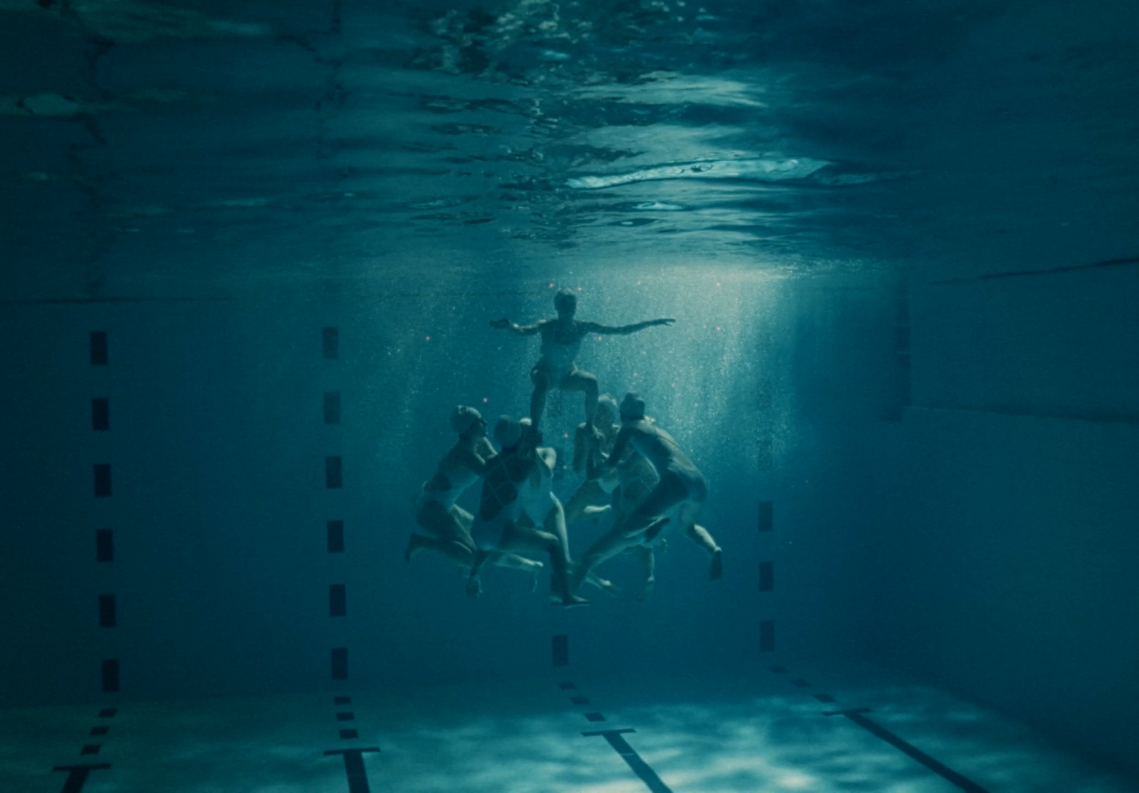 a group of people swimming in a pool