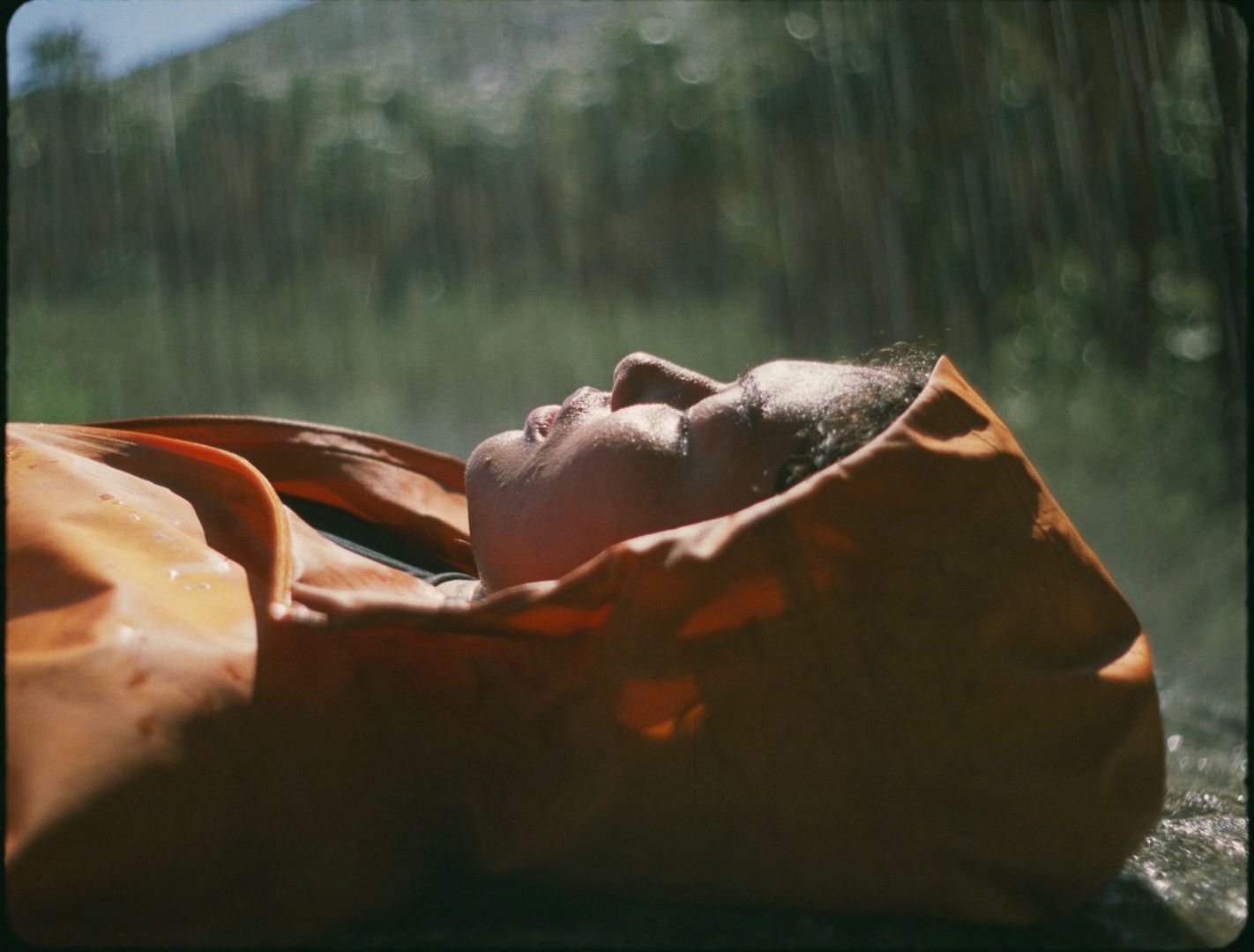 a person laying down in an orange blanket