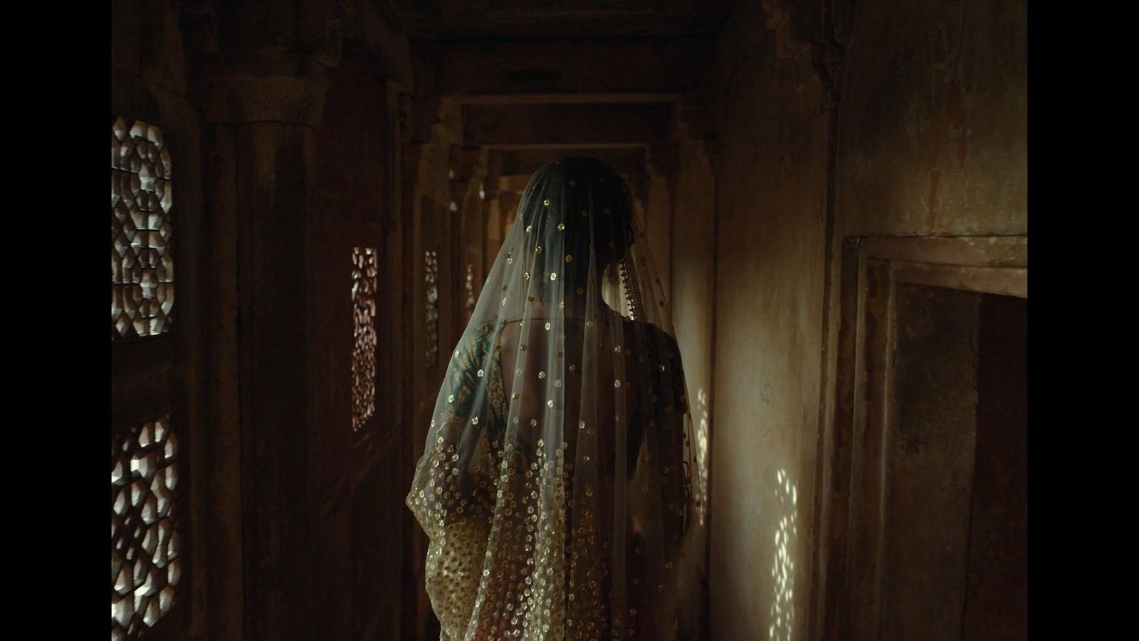 a woman in a veil standing in a doorway