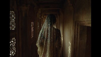 a woman in a veil standing in a doorway