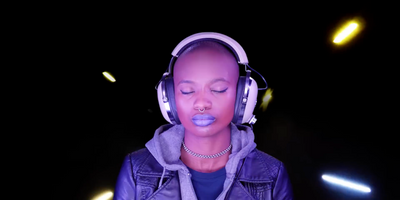 a woman wearing headphones and a purple jacket