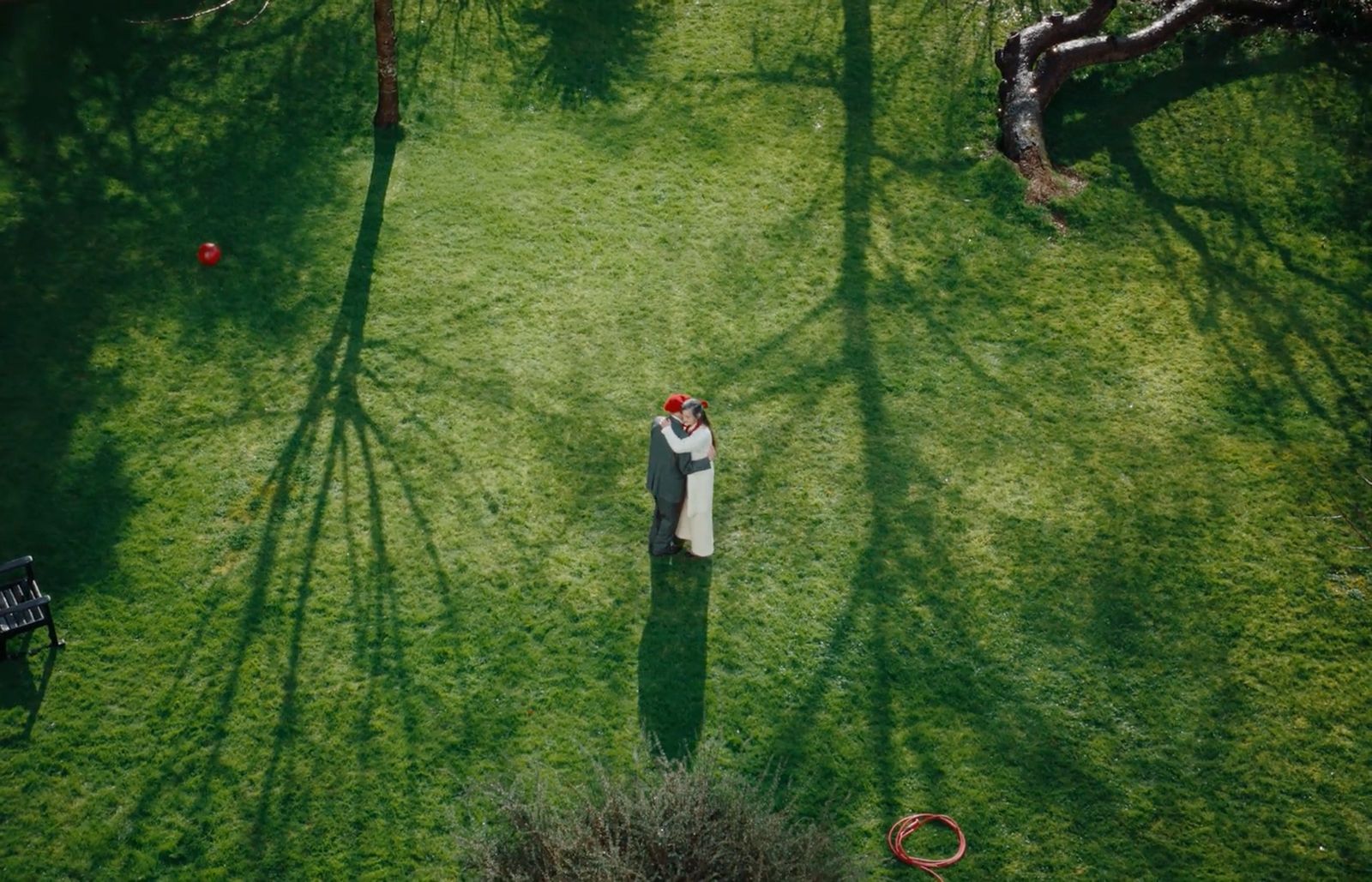 a man and a woman standing in the middle of a field