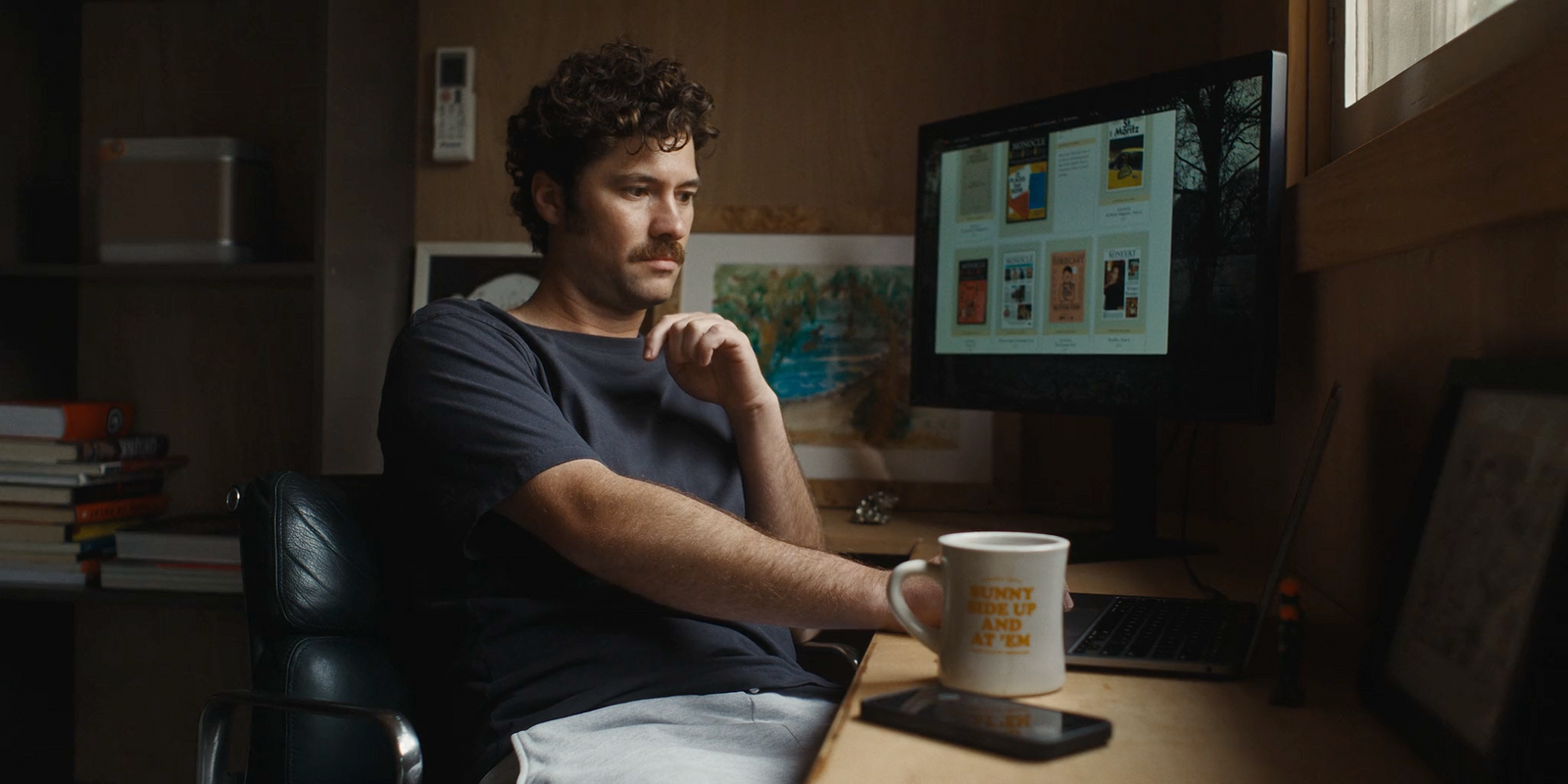 a man sitting at a desk in front of a computer