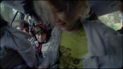 a group of young children riding in the back of a car