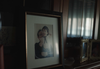 a framed photograph of a young child in a room