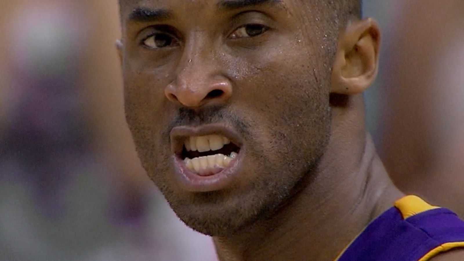 a close up of a basketball player wearing a purple uniform