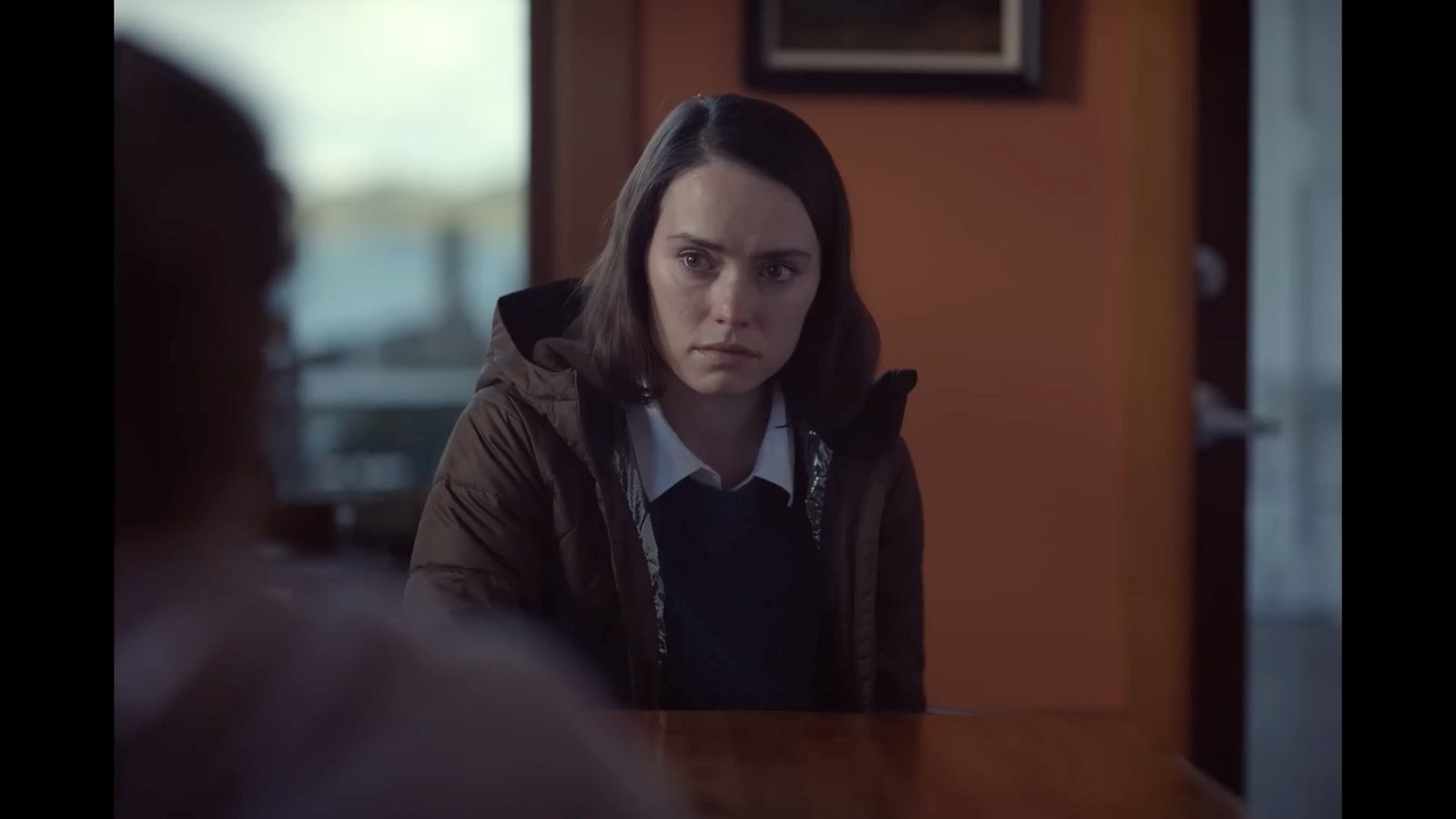 a woman sitting at a table in a room