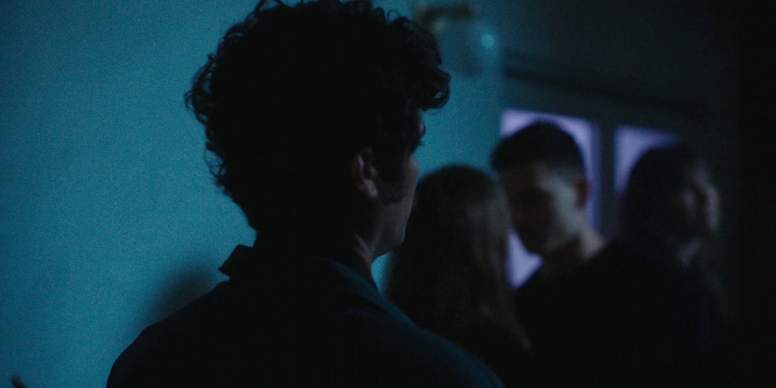 a group of people standing in a dark room