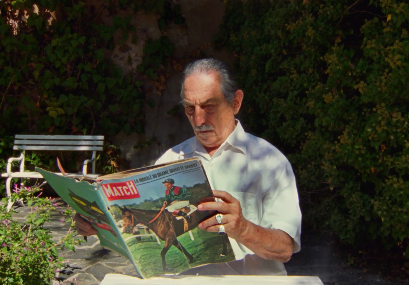 a man sitting at a table reading a magazine